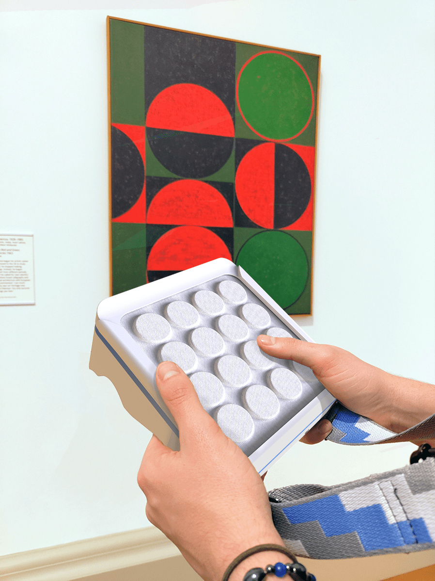Two hands holding a square device in front of an abstract artwork in a gallery