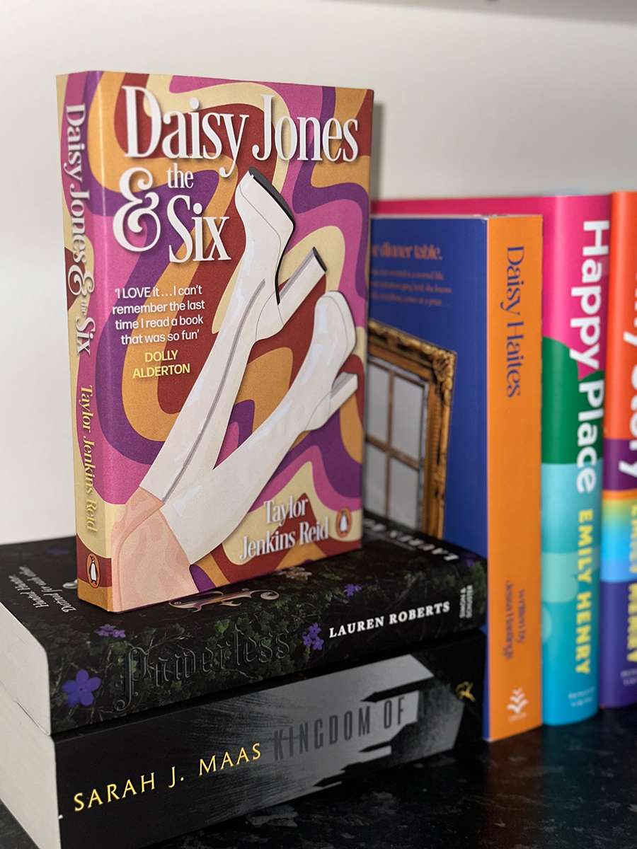 Physical Daisy Jones and the Six Mock Up book standing on pile of books.