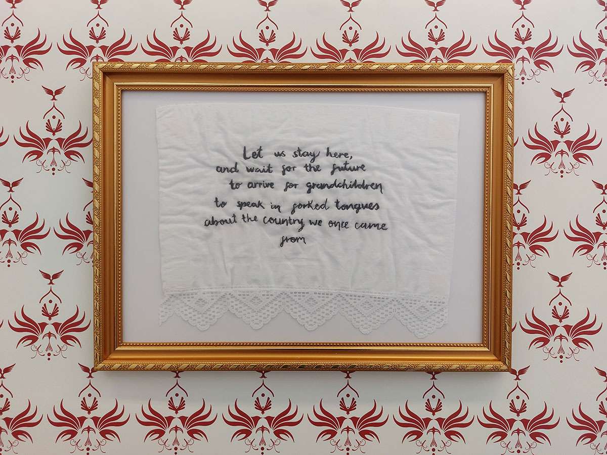 Embroidered doily with text, framed