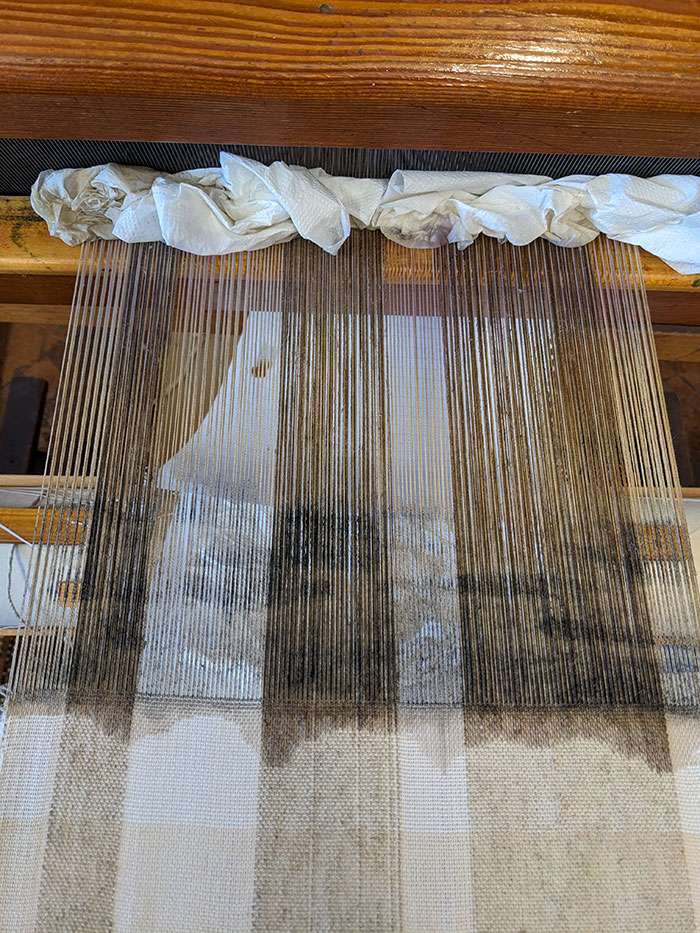 One of my warps on the loom, painted with natural dye extracts
