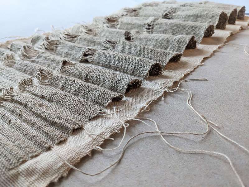 Sample of pleats, going from small to large in size to highlight the gradual loss of land mass. Woven with linen yarn as the weft and Seacell and linen as the warp.