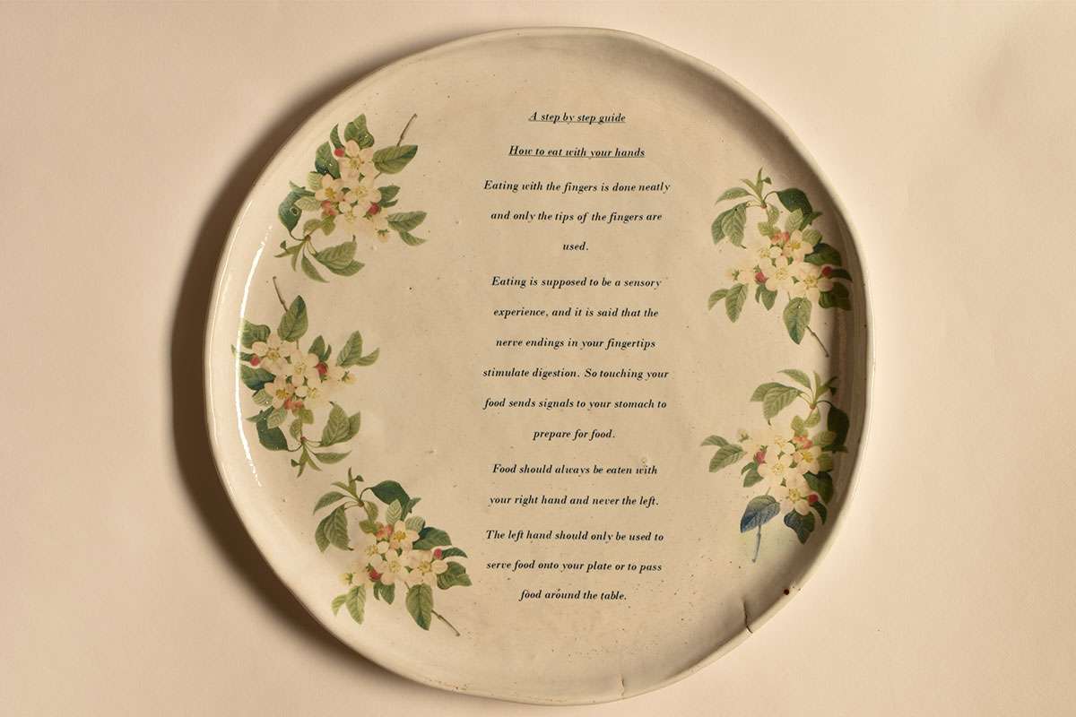 Ceramic plate with ceramic transfer text and floral décor. 